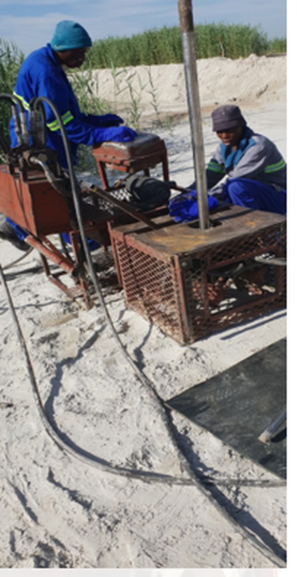 Ukwazi crew operating grout pumping equipment at a tailings storage facility