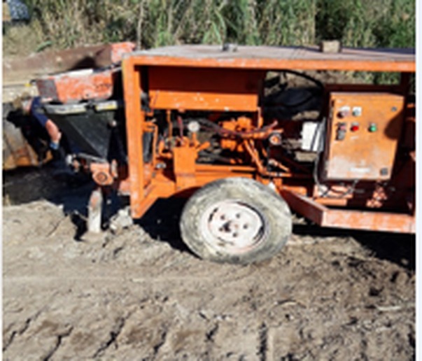 Grout pumping rig operating on a tailings dam wall