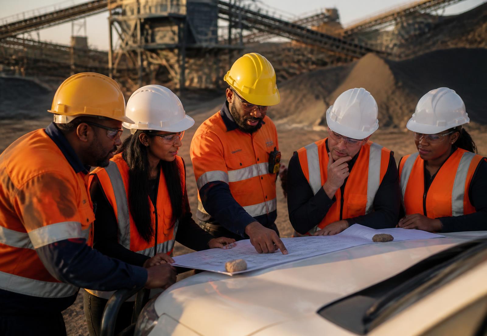 Engineering team reviewing project drawings on a South African mine site